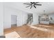 Spacious living room with hardwood floors, featuring a modern staircase and an open concept leading into the kitchen at 1835 Taylor Ave, East Point, GA 30344