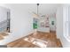 Bright living room with hardwood floors that flows into the kitchen, and a modern staircase with black metal railings at 1835 Taylor Ave, East Point, GA 30344