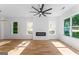 Bright living room with a modern fireplace, large windows, hardwood floors, and a ceiling fan at 1835 Taylor Ave, East Point, GA 30344