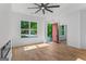 Open living room with hardwood floors, lots of natural light, a modern fireplace, and recessed lighting at 1835 Taylor Ave, East Point, GA 30344