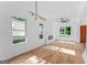 Well-lit living room featuring hardwood floors, large windows, recessed lighting, and a modern light fixture at 1835 Taylor Ave, East Point, GA 30344
