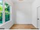 Empty bright room with hardwood floors, a large window, and crisp white walls at 1835 Taylor Ave, East Point, GA 30344