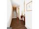 Bright entryway featuring hardwood floors, a staircase, and decorative table adding warmth and character to the home's interior at 756 Cady Way, Atlanta, GA 30312
