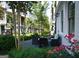 Inviting outdoor seating area surrounded by lush greenery and colorful flowers, perfect for relaxation and entertaining guests at 756 Cady Way, Atlanta, GA 30312