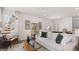 Open living room featuring hardwood floors, modern furniture, a stylish cabinet, and plenty of natural light at 580 Silver Moon Dr, Loganville, GA 30052