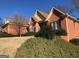 Brick home boasts mature landscaping and architectural details, offering a serene view at 116 Royal Burgess Way, Mcdonough, GA 30253