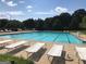 Large community pool with multiple lounge chairs for relaxing by the water at 116 Royal Burgess Way, Mcdonough, GA 30253