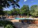 Community pool with ample seating, covered area, and well-maintained surroundings at 116 Royal Burgess Way, Mcdonough, GA 30253