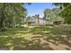 Expansive backyard features lush green lawn, a large deck, and mature trees for shade and privacy at 109 Cannon Road, Sharpsburg, GA 30277