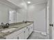 Bright bathroom featuring a double sink vanity with granite countertop at 109 Cannon Road, Sharpsburg, GA 30277