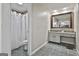 Bathroom with a shower and well-lit vanity featuring a large mirror at 109 Cannon Road, Sharpsburg, GA 30277