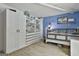 Well-organized bedroom with built-in shelving and blue accent wall at 109 Cannon Road, Sharpsburg, GA 30277