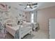 Charming bedroom featuring twin beds, floral wallpaper, and a ceiling fan at 109 Cannon Road, Sharpsburg, GA 30277