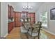 Inviting dining room features wood floors, modern lighting and wooden table with seating at 109 Cannon Road, Sharpsburg, GA 30277