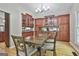 Inviting dining room features wood floors, modern lighting and wooden table with seating at 109 Cannon Road, Sharpsburg, GA 30277