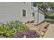 Charming exterior with neutral siding is complemented by rock landscaping and lush plants at 109 Cannon Road, Sharpsburg, GA 30277