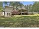 A back view shows a screened porch with stairs, a deck, and a walkout basement at 109 Cannon Road, Sharpsburg, GA 30277