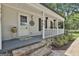 Inviting front porch with stone accents and decorative hanging flower baskets at 109 Cannon Road, Sharpsburg, GA 30277