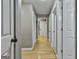 Hallway with hardwood floors and multiple entryways to other rooms at 109 Cannon Road, Sharpsburg, GA 30277