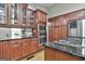 Spacious kitchen features wood cabinets, granite countertops and stainless steel appliances at 109 Cannon Road, Sharpsburg, GA 30277