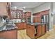 Spacious kitchen featuring cherry cabinets, granite countertops, and modern appliances at 109 Cannon Road, Sharpsburg, GA 30277