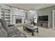 Bright living room featuring a painted brick fireplace, entertainment center, and exercise bike at 109 Cannon Road, Sharpsburg, GA 30277