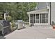 Outdoor grilling station with stainless steel grill and prep space, adjacent to the screened-in porch and deck at 109 Cannon Road, Sharpsburg, GA 30277