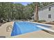 Beautiful in-ground swimming pool with diving board, patio, landscaping, and outdoor seating for relaxation at 109 Cannon Road, Sharpsburg, GA 30277