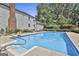 Sparkling in-ground swimming pool with diving board, surrounded by lush greenery and a well-maintained fence at 109 Cannon Road, Sharpsburg, GA 30277