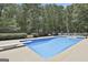 A refreshing in-ground pool features a diving board and plenty of space for outdoor entertaining at 109 Cannon Road, Sharpsburg, GA 30277