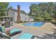 Backyard featuring a swimming pool, wooden deck with chaise lounges, and an inviting outdoor space at 109 Cannon Road, Sharpsburg, GA 30277