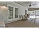 Comfortable screened porch features neutral tones, plush seating, ceiling fan, and access to the backyard and pool at 109 Cannon Road, Sharpsburg, GA 30277