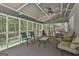 Spacious screened-in porch featuring comfortable seating arrangements, and tranquil views of the surrounding landscape at 109 Cannon Road, Sharpsburg, GA 30277