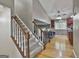 Carpeted staircase leading to a light-filled area with hardwood floors at 109 Cannon Road, Sharpsburg, GA 30277