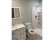 Updated bathroom with a bright white shower, light green walls, and a modern vanity at 2934 Union Grove Rd, Conyers, GA 30012