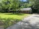 Charming brick home featuring an attached garage and a sprawling front yard with mature trees at 2934 Union Grove Rd, Conyers, GA 30012