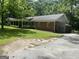 Charming brick home featuring an attached garage and a sprawling front yard with mature trees at 2934 Union Grove Rd, Conyers, GA 30012