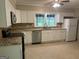 Bright kitchen featuring granite counters, white cabinets, and stainless steel appliances at 2934 Union Grove Rd, Conyers, GA 30012