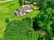 A scenic aerial view captures a home nestled among green spaces and mature trees at 260 Sams Dr, Fayetteville, GA 30214
