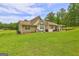 Home back exterior view with backyard, patio, and open space at 260 Sams Dr, Fayetteville, GA 30214