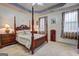 Bedroom with four poster bed and an ensuite bath has plenty of room to relax at 260 Sams Dr, Fayetteville, GA 30214