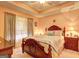 Comfortable bedroom features a wood sleigh bed, neutral carpet, and soft, filtered natural light at 260 Sams Dr, Fayetteville, GA 30214