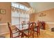 Cozy dining room with a chandelier, hardwood floors, and a large window overlooking the neighborhood at 260 Sams Dr, Fayetteville, GA 30214
