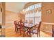 Elegant dining room featuring hardwood floors, a chandelier, and a large window with decorative curtains at 260 Sams Dr, Fayetteville, GA 30214