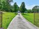 Long driveway leading to home with beautiful landscaping along the way at 260 Sams Dr, Fayetteville, GA 30214