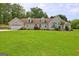 Charming single-story home featuring an attached garage, dormer windows, and a well-manicured lawn at 260 Sams Dr, Fayetteville, GA 30214