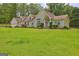 Beautiful front exterior featuring an attached garage, dormer windows, and a well-manicured lawn at 260 Sams Dr, Fayetteville, GA 30214