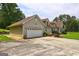 Side angle of this home with garage, dormer windows, concrete driveway and beautiful shrubbery at 260 Sams Dr, Fayetteville, GA 30214