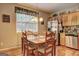 Kitchen with stainless steel appliances, light wood cabinets, granite countertops, and breakfast nook area at 260 Sams Dr, Fayetteville, GA 30214