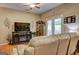 Cozy living room features a fireplace, ceiling fan, and french doors to the outside at 260 Sams Dr, Fayetteville, GA 30214